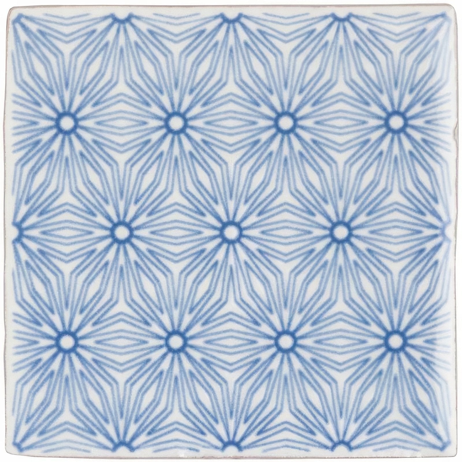 A square ceramic tile manoire fleur on papyrus with a repeating blue geometric pattern on a white background