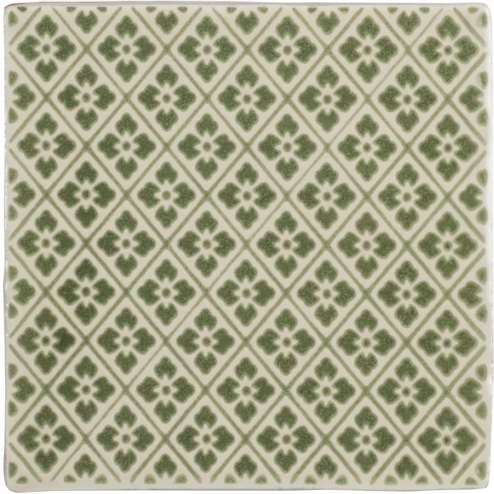 Square ceramic Manoir Provence pumice tile with repeating green quatrefoil pattern on off-white background
