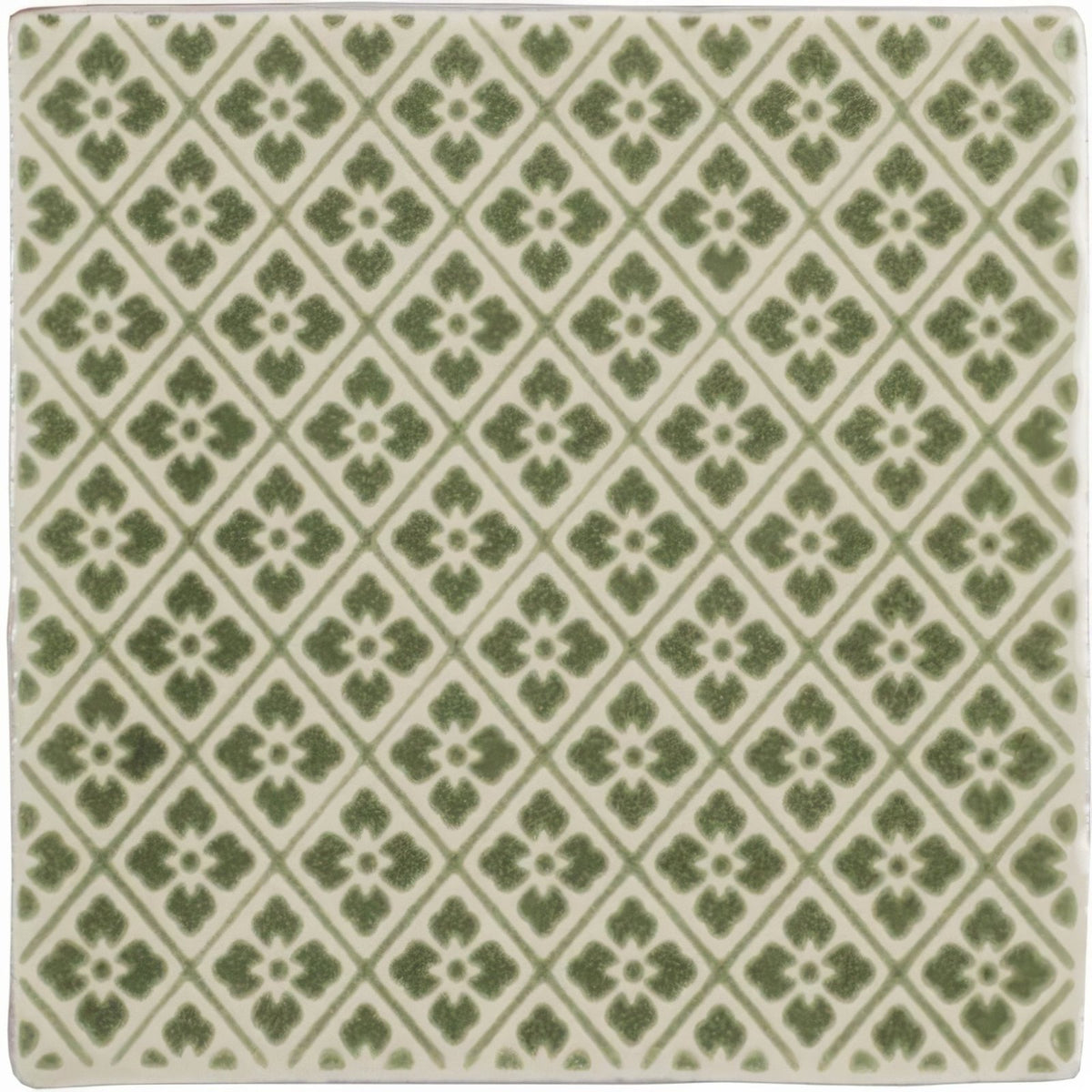 Square ceramic Manoir Provence pumice tile with repeating green quatrefoil pattern on off-white background
