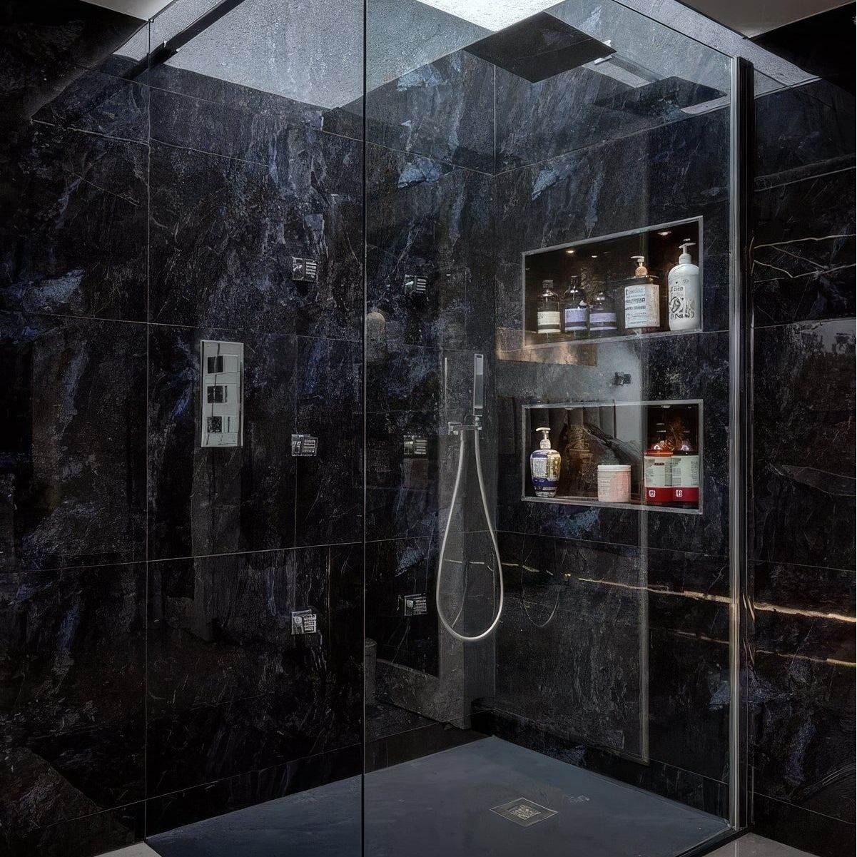 Marble Ocean Rock dark blue marble-effect tiles in a shower enclosure with glass panels and shelves
