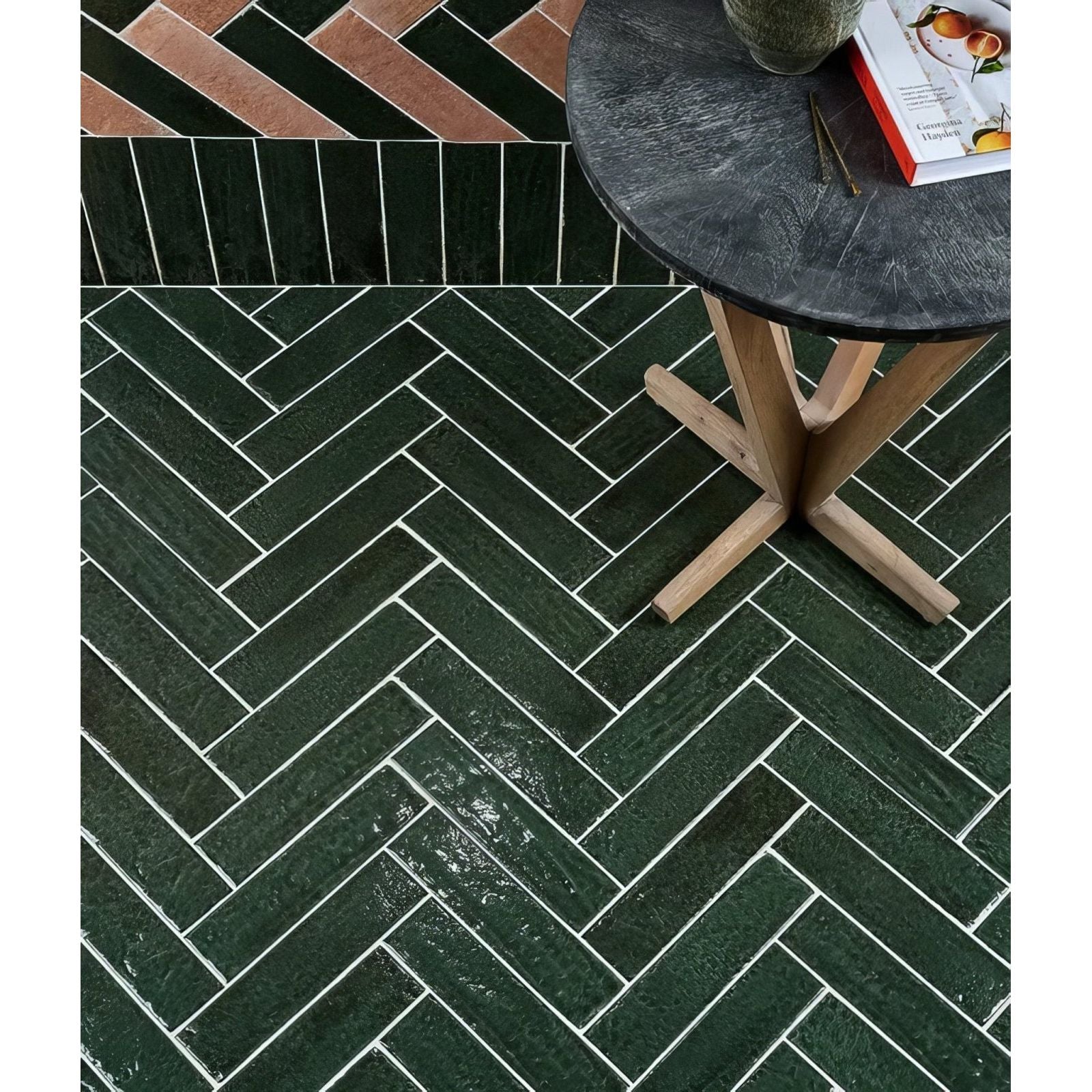 Dark green herringbone patterned marlborough porcelain parquet floor tiles with white grout lines and glossy finish