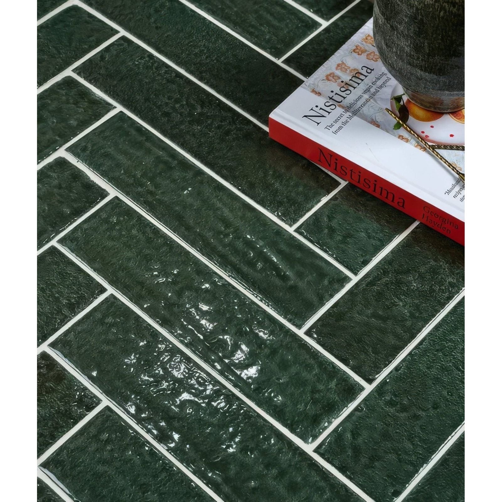 Dark green marlborough porcelain parquet tiles with textured herringbone pattern and white grout in gloss finish