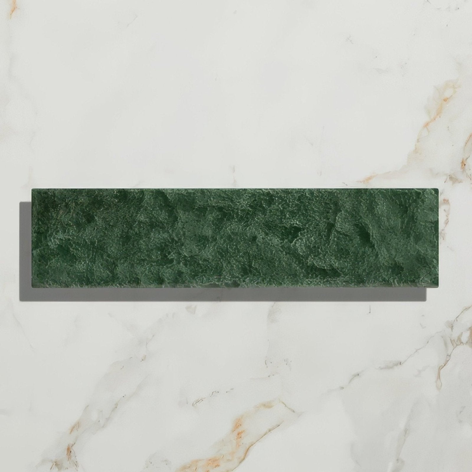 A rectangular deep green marble marlborough porcelain parquet tile with natural textured veining and forest green gloss