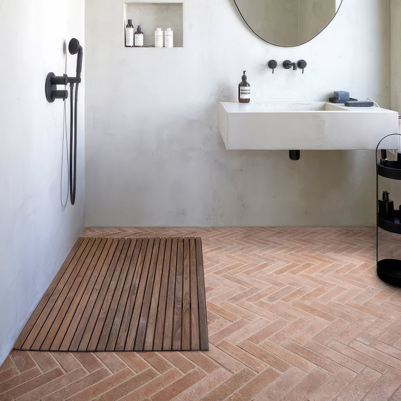 A rectangular wooden shower mat with a natural brown finish and visible wood grain on marlborough porcelain parquet natural floor