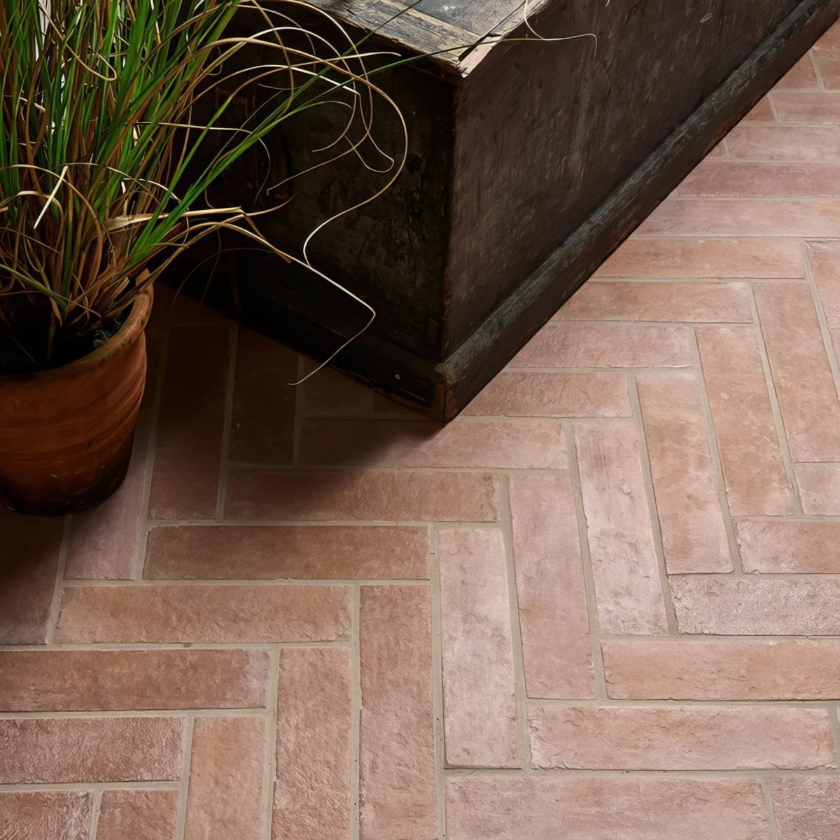 Terracotta colored marlborough porcelain parquet natural floor tiles with herringbone pattern for indoor use