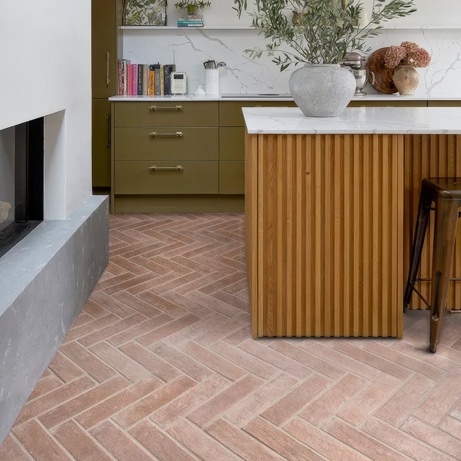 A marlborough porcelain parquet natural gray matte finish ceramic vase with a rounded body on a marble countertop