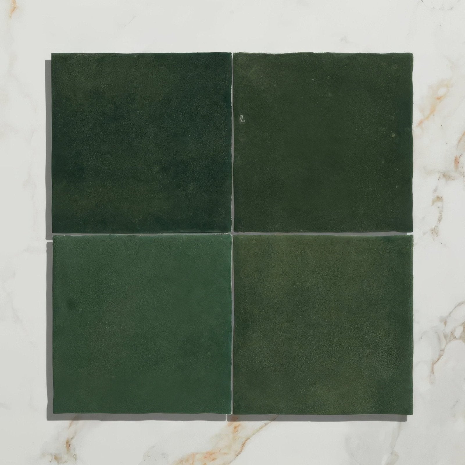 Four square dark green ceramic tiles from maroc ceramic forest with a glossy finish arranged in a grid