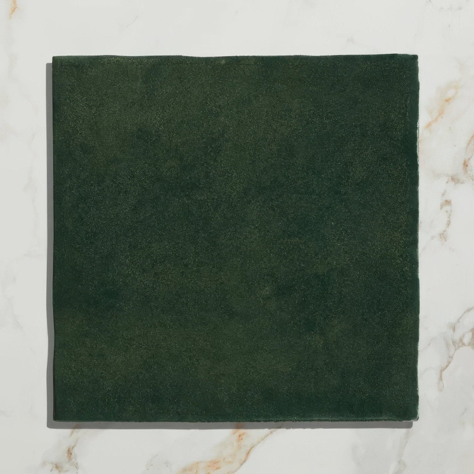 Dark green suede square tile from maroc ceramic forest collection showcasing textured ceramic material