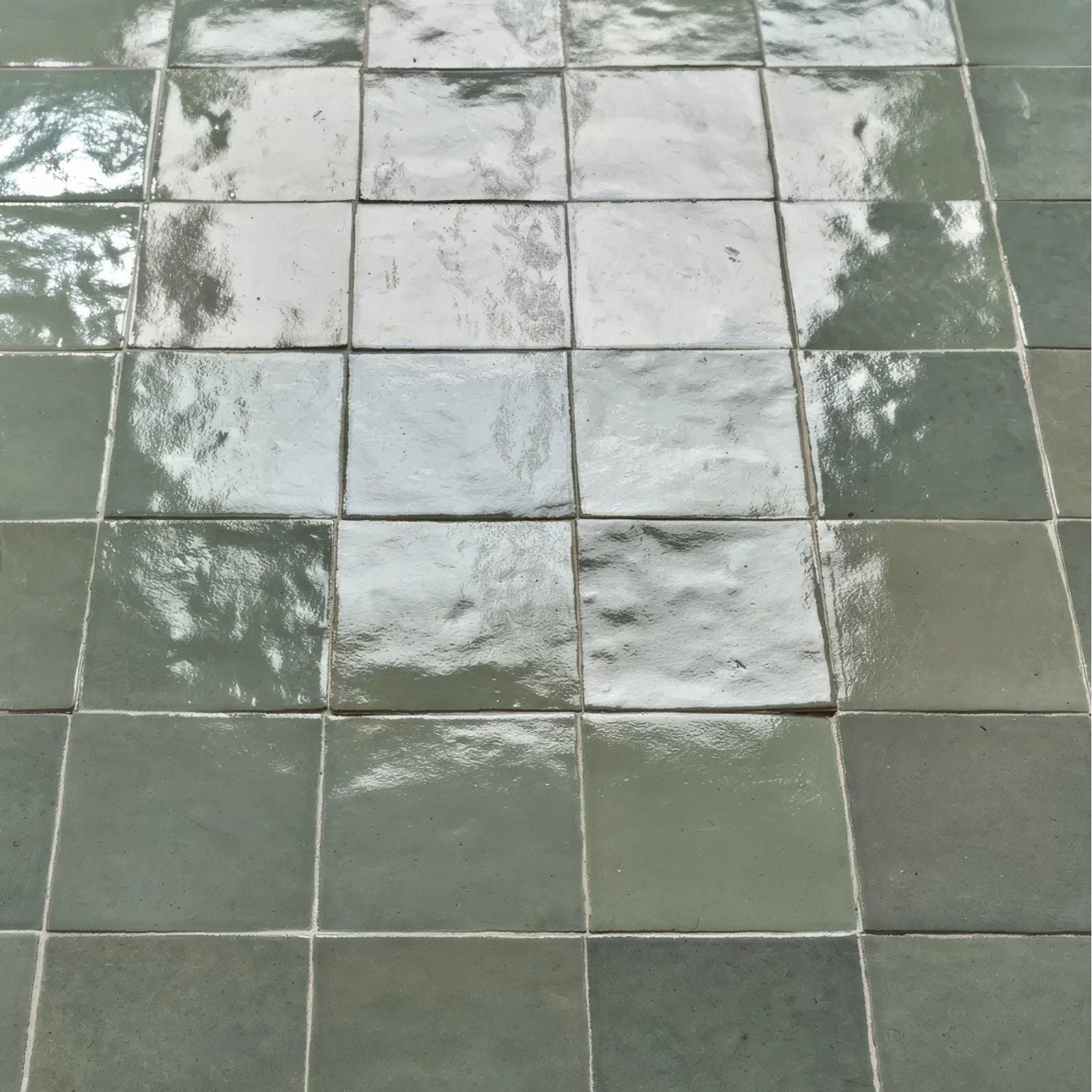 Maroc ceramic mint square glossy gray tiles with subtle textured surface and faint foliage reflections