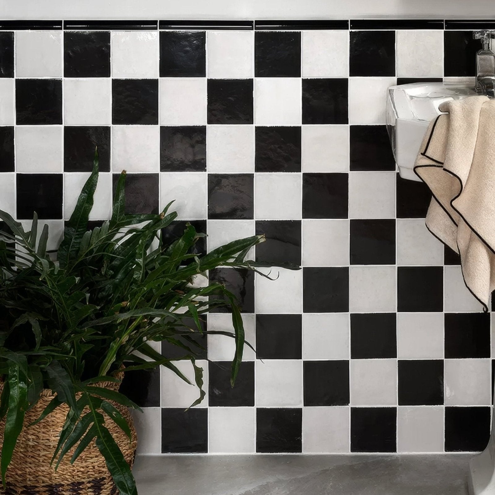 Black and white checkered ceramic tiles from Maroc Ceramic Nero create a bold high contrast backsplash design