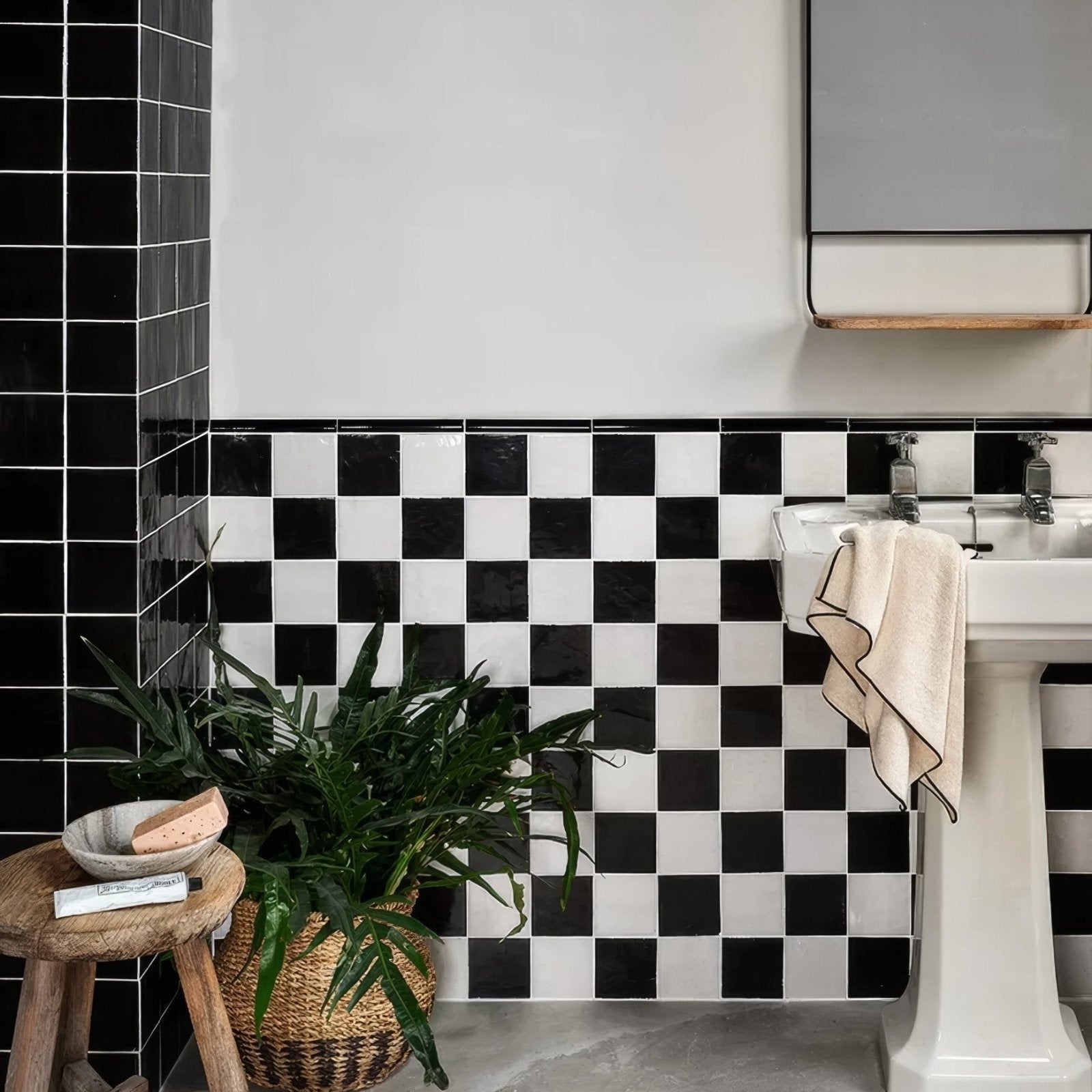 Maroc Ceramic Nero black and white ceramic tiles with a white pedestal sink