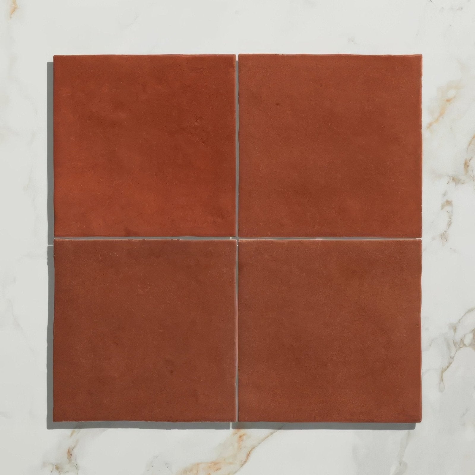 Four square terracotta maroc ceramic tomato tiles in warm reddish brown with a matte finish arranged in a grid