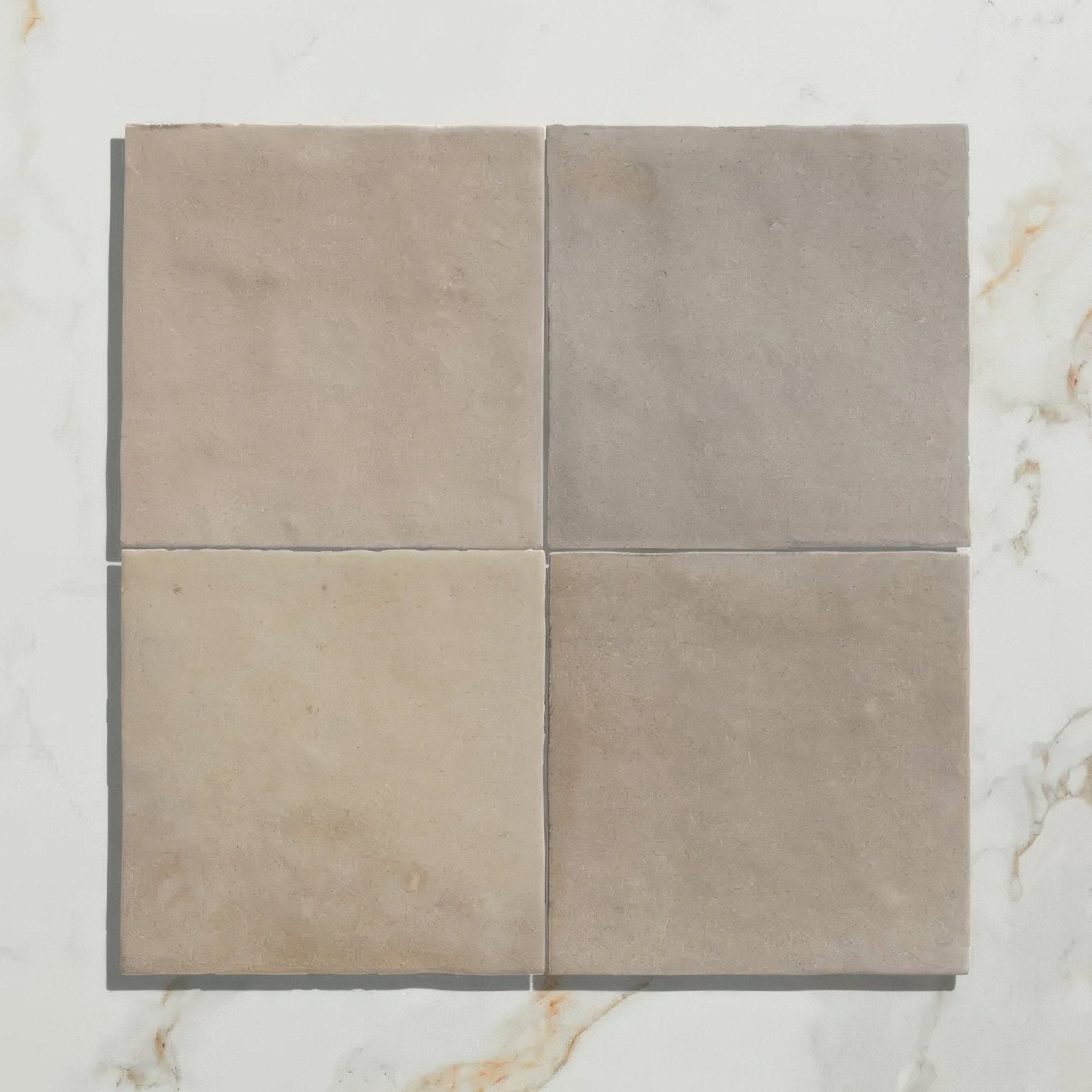 Four square beige ceramic wool tiles with a matte slightly textured surface arranged in a grid for wall or floor use