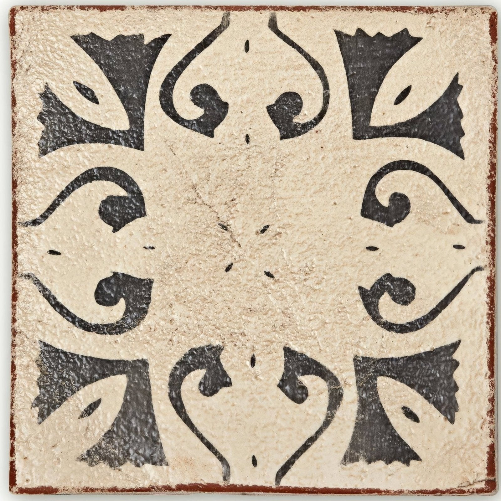 Cream-colored ceramic Marrakech Hammam patterned terracotta tile with black stylized floral and scrollwork designs