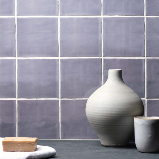 A matte gray ceramic vase with a rounded body and slender neck featured in marsh field tile product design