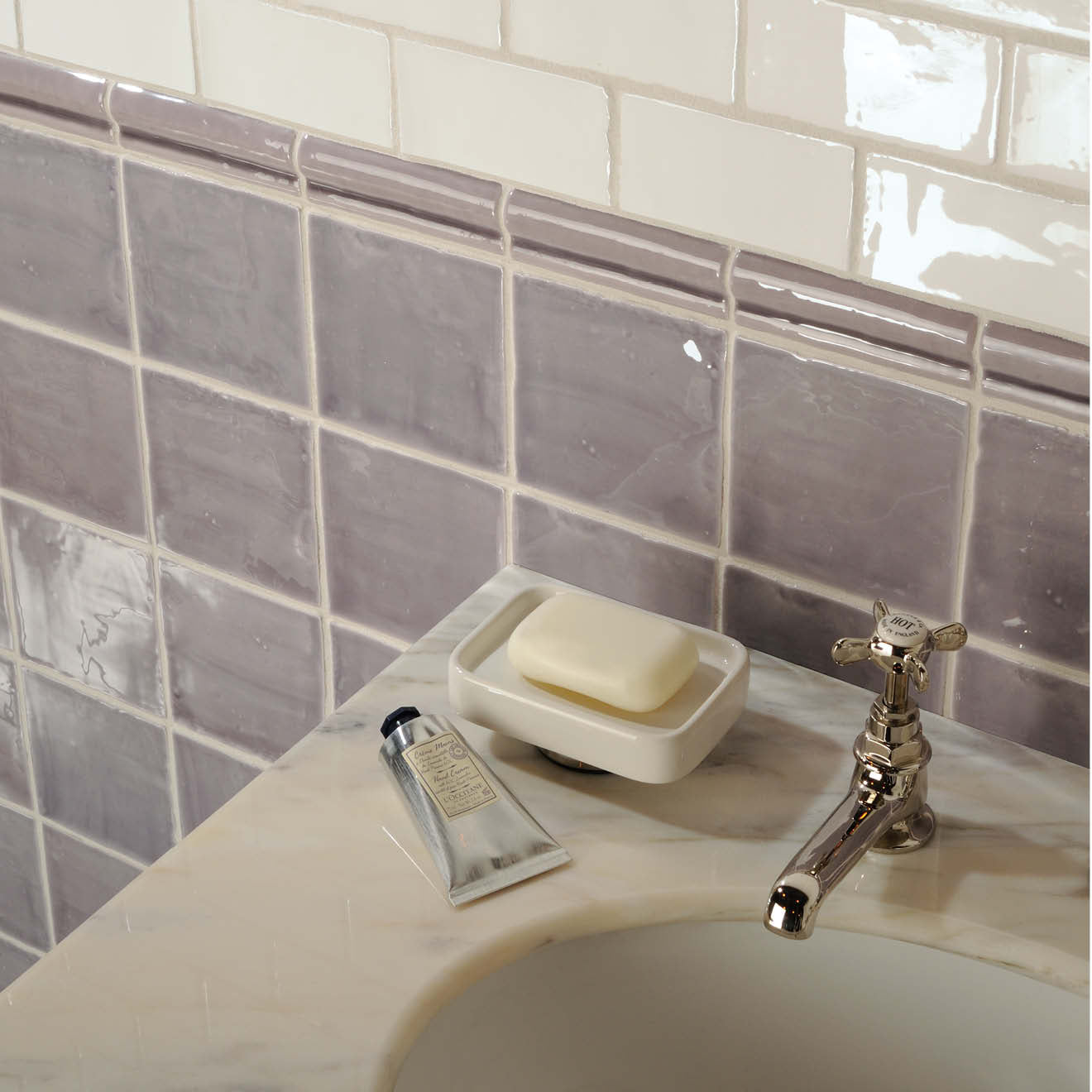 A sleek silver tube of marsh field tile hand cream with a black cap and elegant gold lettering