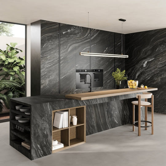 Marvel Diva Black Tempest Velvet dark grey marble-effect tiles with a kitchen island and wooden shelves