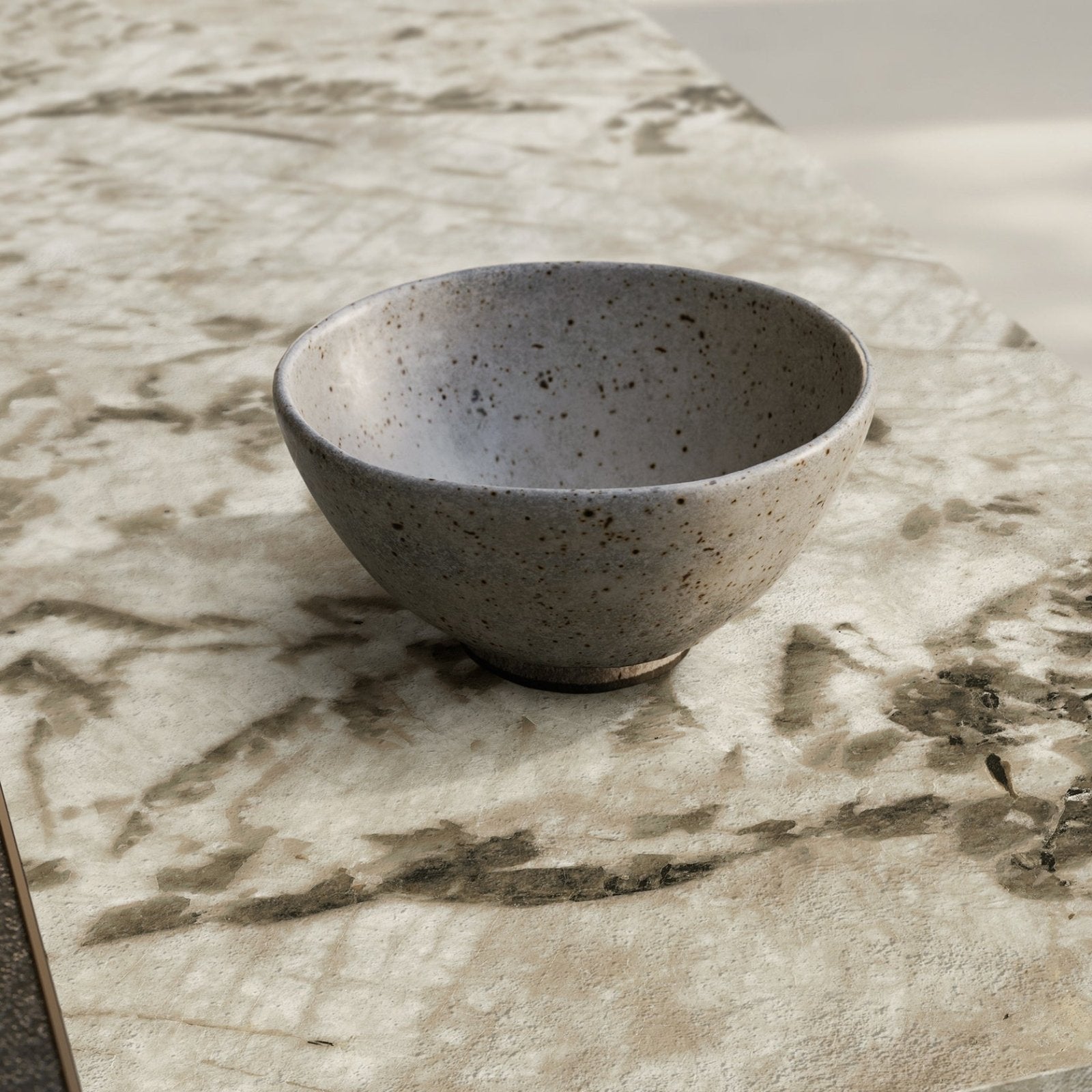 Marvel Epic Alpin white and grey marble-effect porcelain tile with a grey ceramic bowl