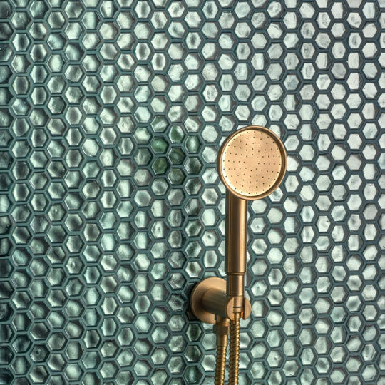 Medak Glass Mosaic teal glass mosaic with a gold showerhead