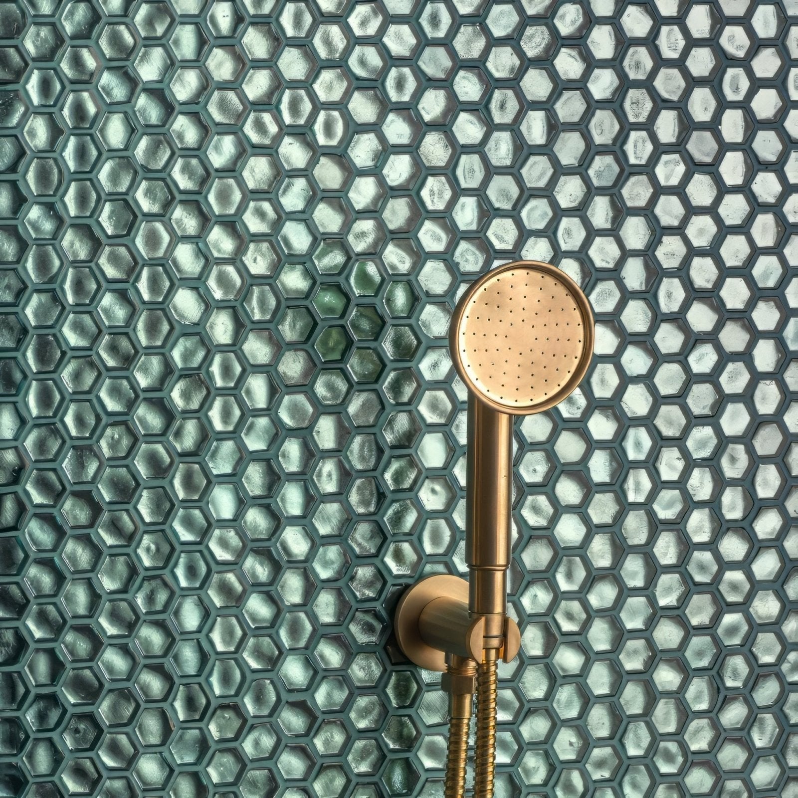 Medak Glass Mosaic teal glass mosaic with a gold showerhead
