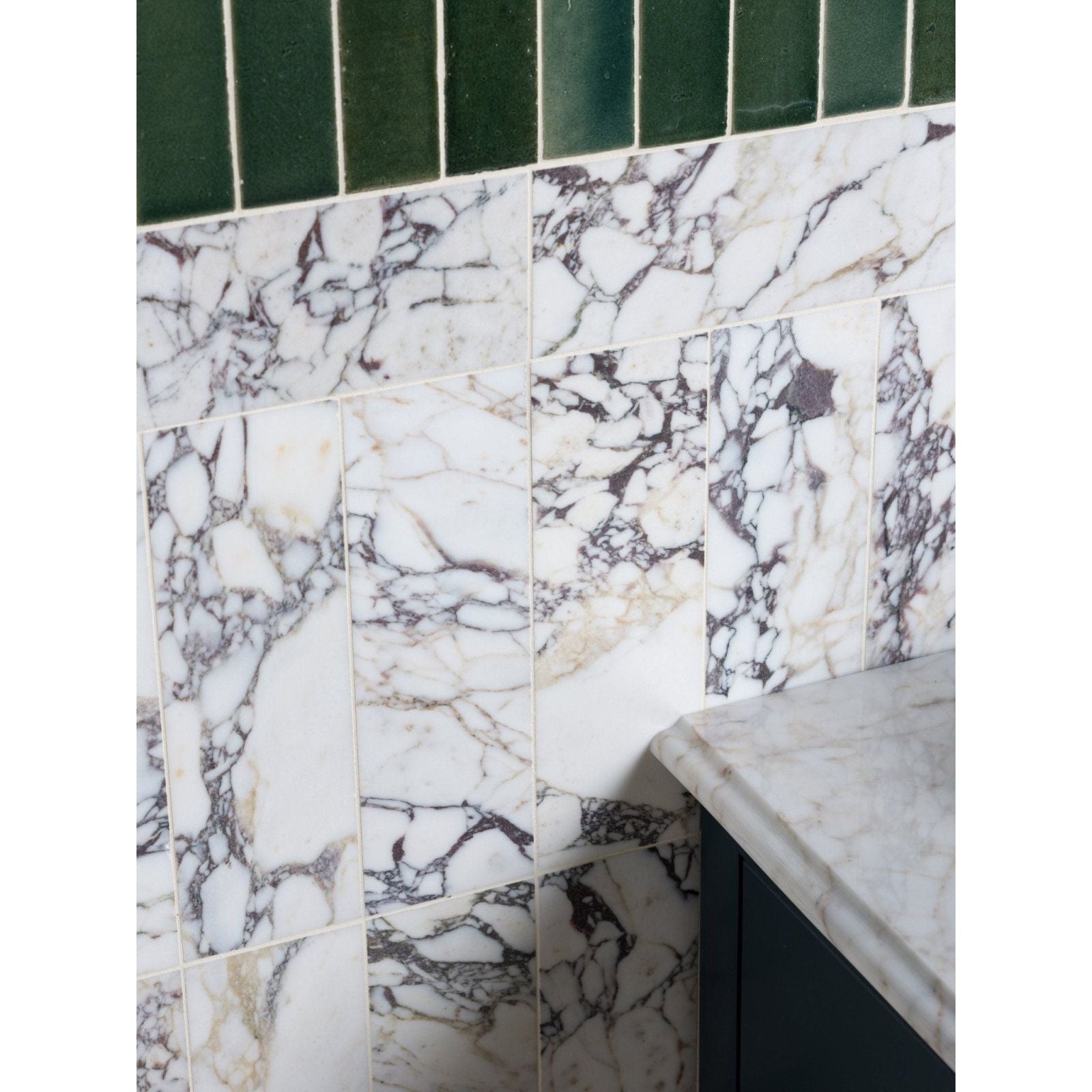 Medici viola marble honed brick tiles in white with black and gray veining topped by dark green rectangular tiles