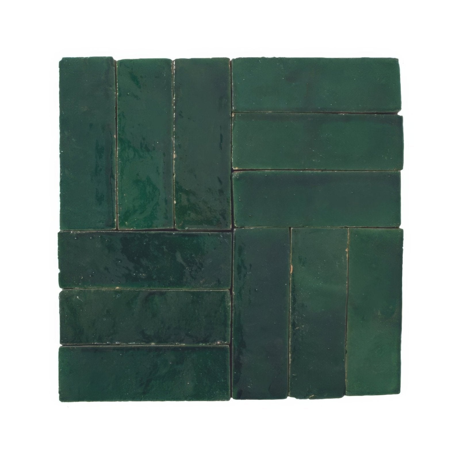Dark green rectangular ceramic tiles arranged in a herringbone pattern from medina moss green zellige rectangle collection