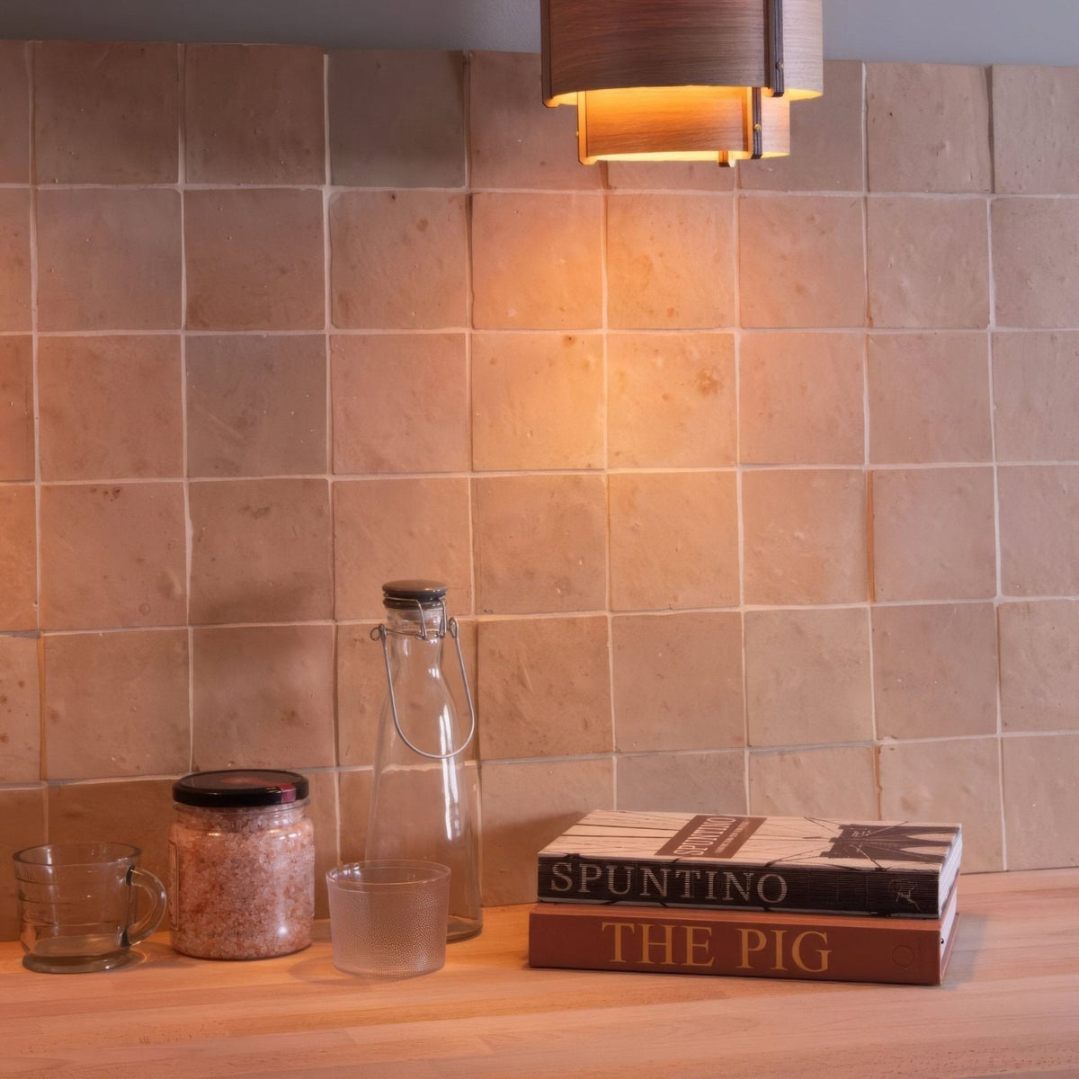 A warm-toned square ceramic Medina raw handmade Moroccan zellige tile backsplash with subtle texture and grout lines