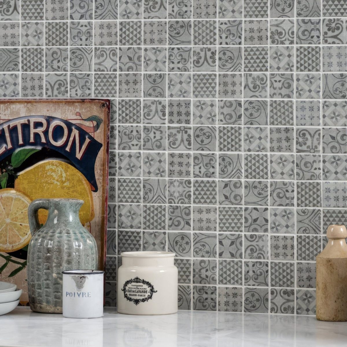Gray medine patterned mosaic tile wall with intricate repeating patterns in varying gray and white shades