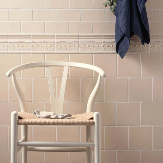 White wishbone chair with woven natural fiber seat and backrest in melford field tile design