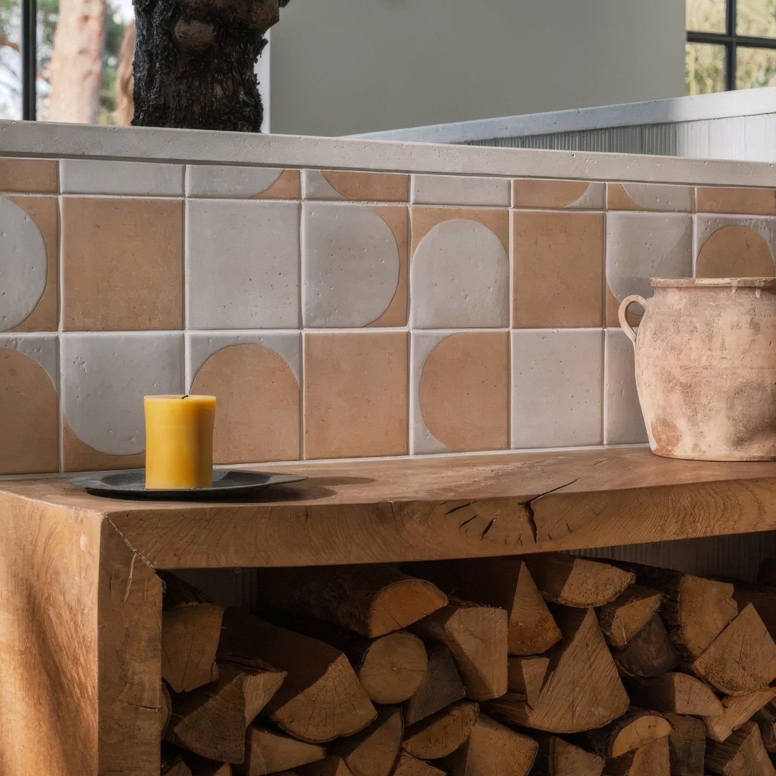 A rustic terracotta menara cotto arches porcelain pot with two handles and an earthy finish on a wooden shelf