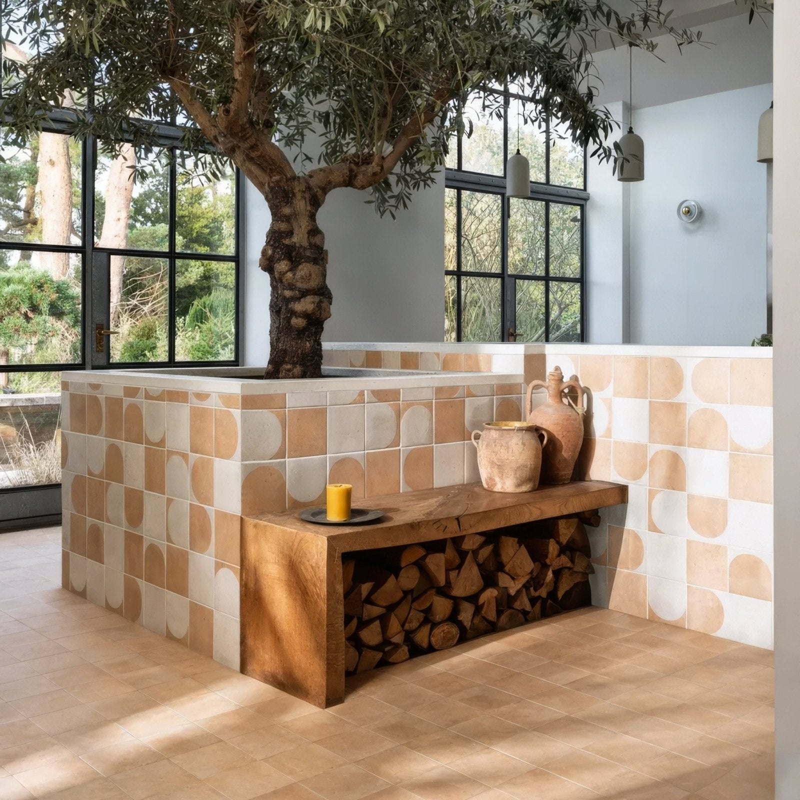 A rustic wooden bench with natural finish and terracotta pots on top featuring stacked firewood below in menara white arches porcelain style