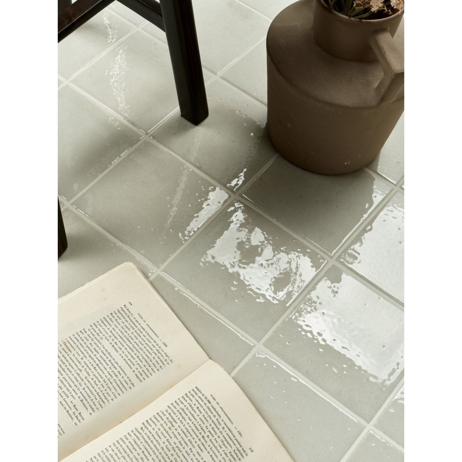 Menara white porcelain gloss floor tiles in light gray with glossy finish subtle texture and visible grout lines