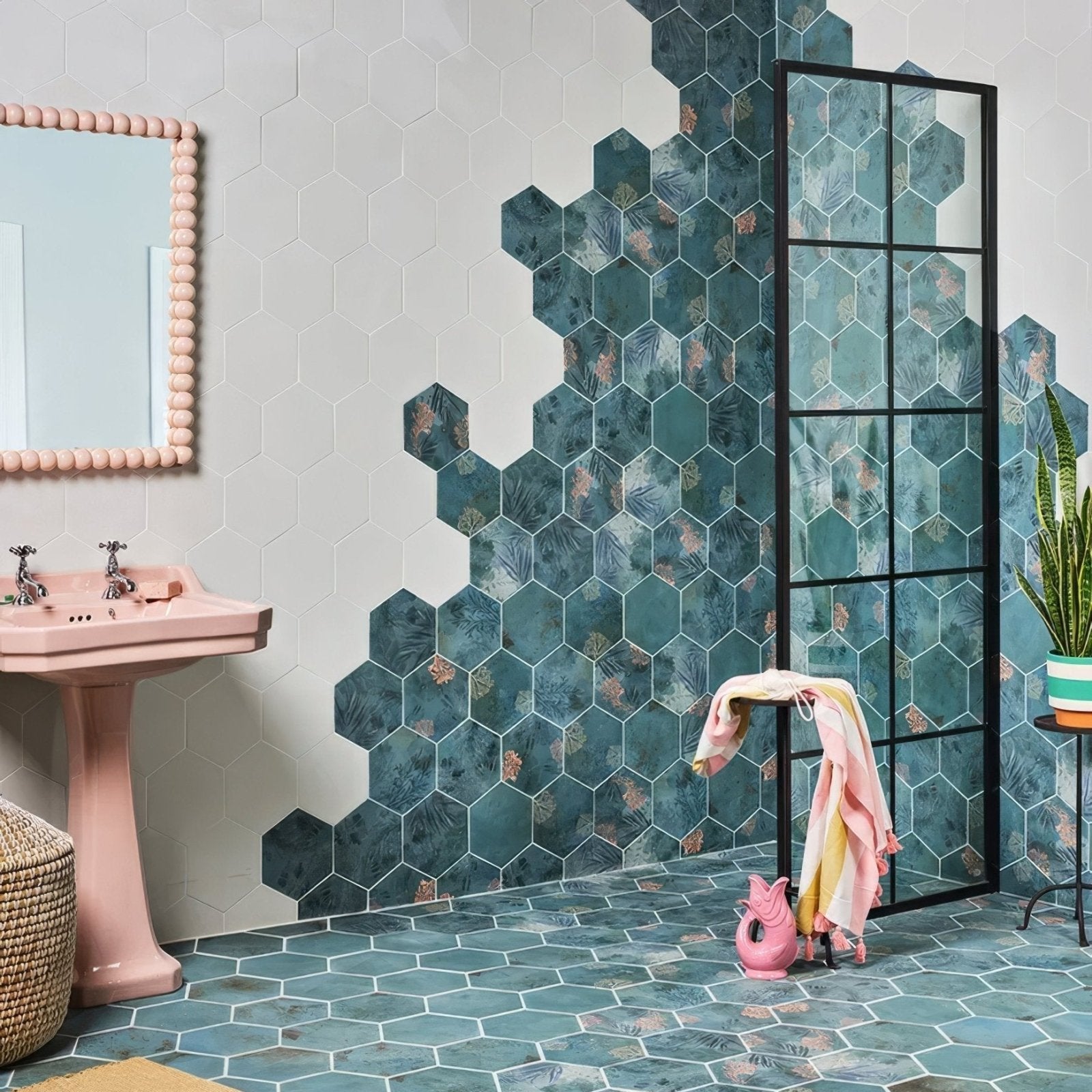 Teal hexagonal porcelain tiles with botanical pattern adorn bathroom walls and floor in mermaids garden design