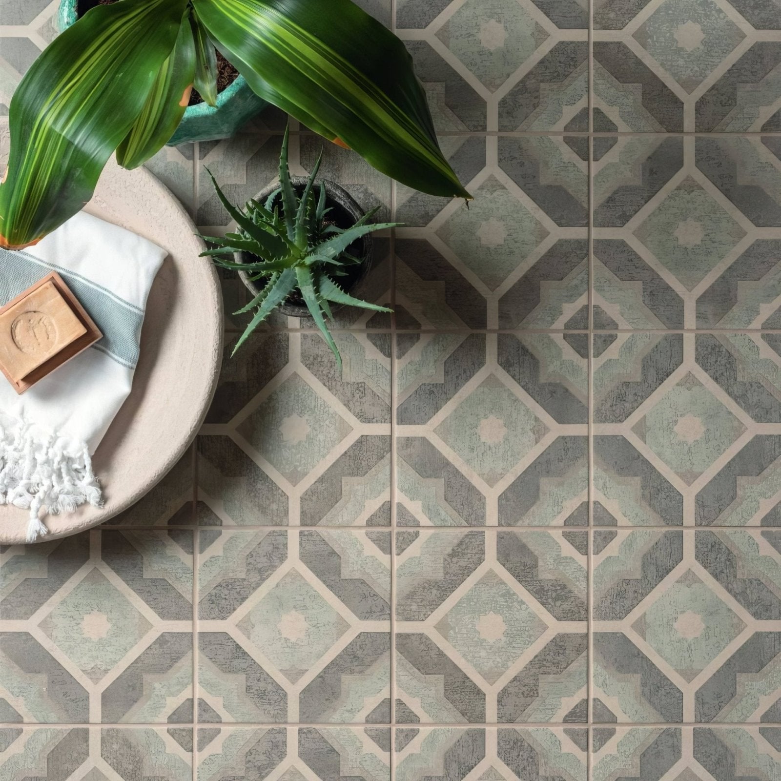 Mezzo Volante geometric patterned floor tiles in muted gray and beige tones with a subtle distressed finish