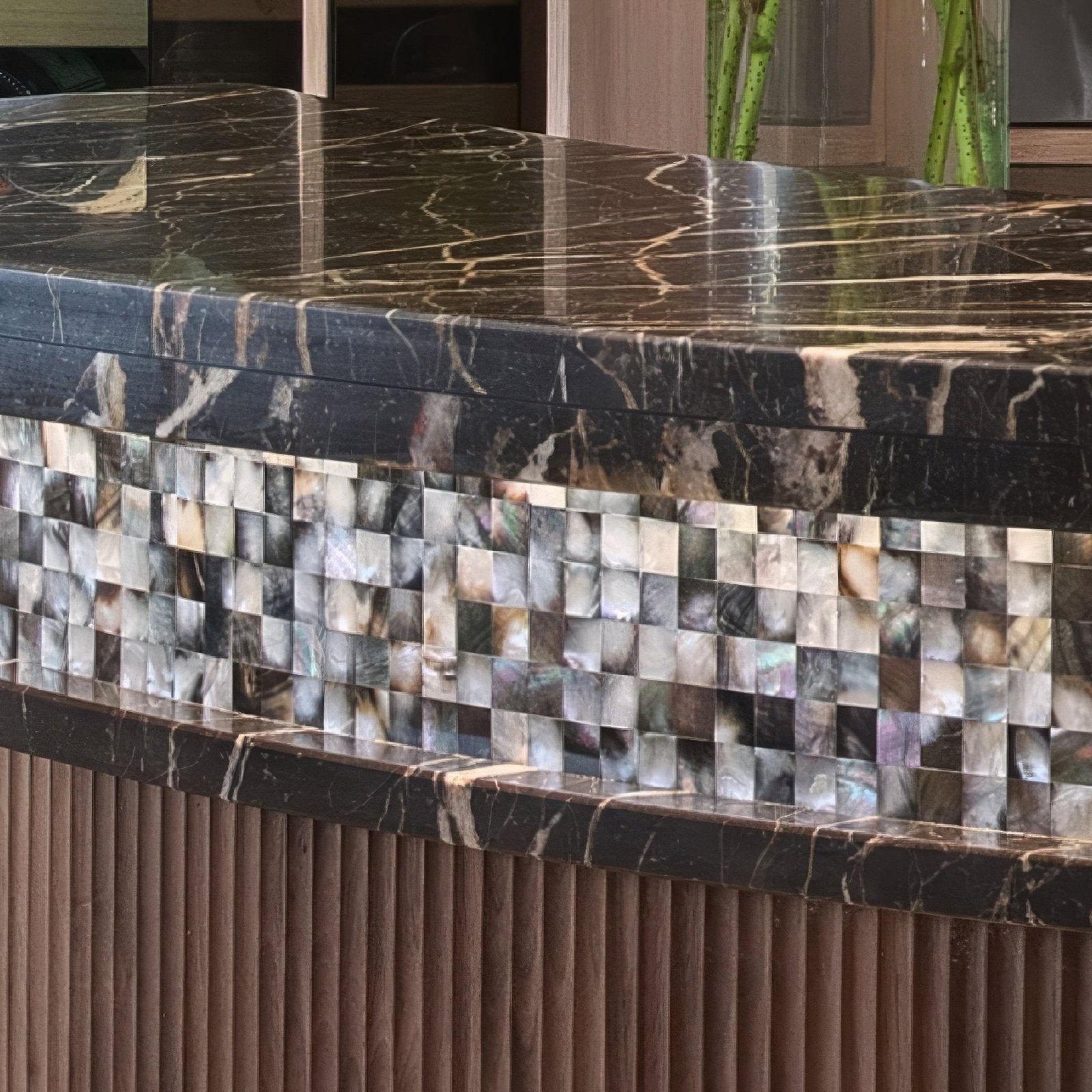 Midnight Pearl 25mm Square iridescent abalone shell mosaic below a black marble countertop
