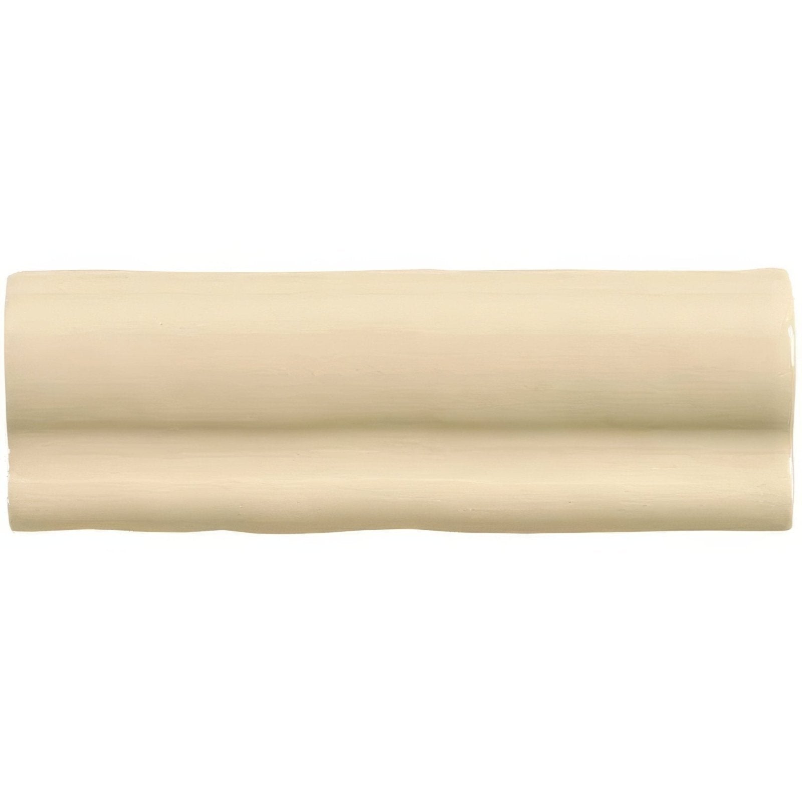 Cream-colored glossy ceramic tile mimosa torus moulding with subtle wavy texture for decorative edging