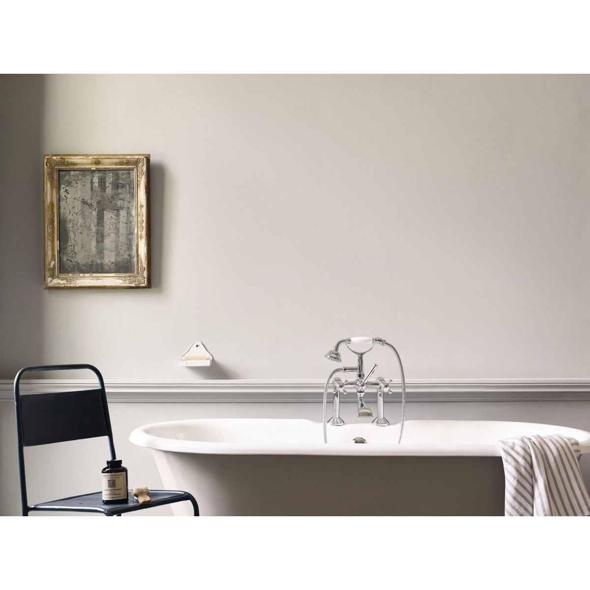 Modernist white freestanding bathtub in white with chrome faucet and overflow spout for a sleek bathroom look