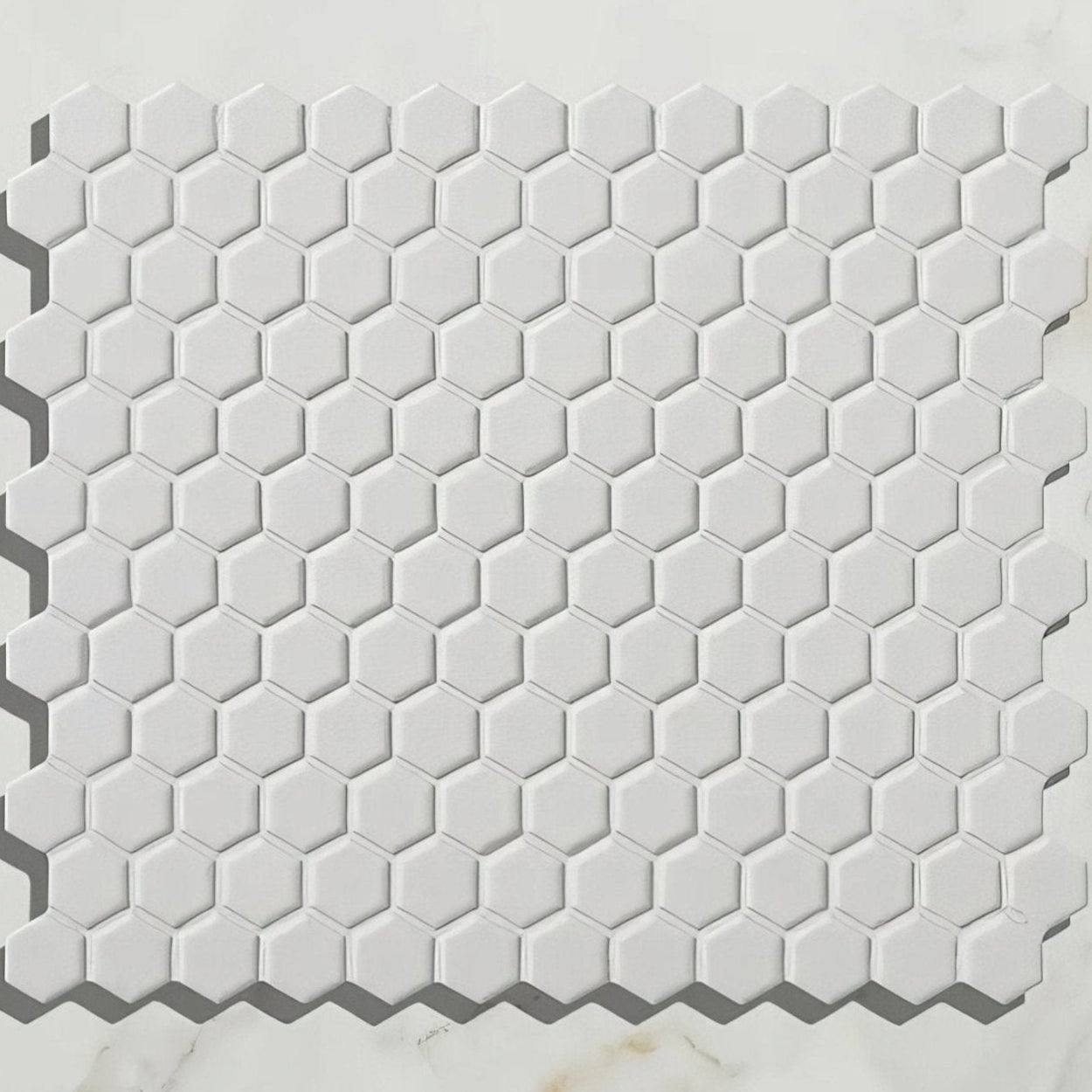 Mono Hex porcelain mosaic blanc with white hexagonal tiles featuring a subtle matte finish and raised edges