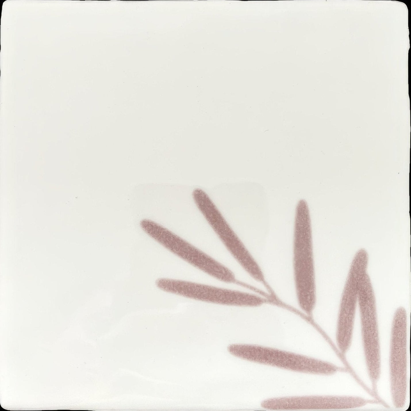 A square white ceramic tile with a subtle mauve leaf pattern in the corner from montagne tayberry 1 collection