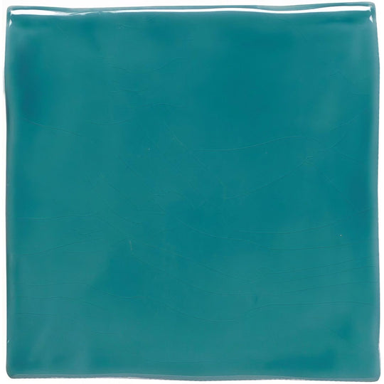 A square glossy teal ceramic tile with subtle texture from the moonstone field tile collection