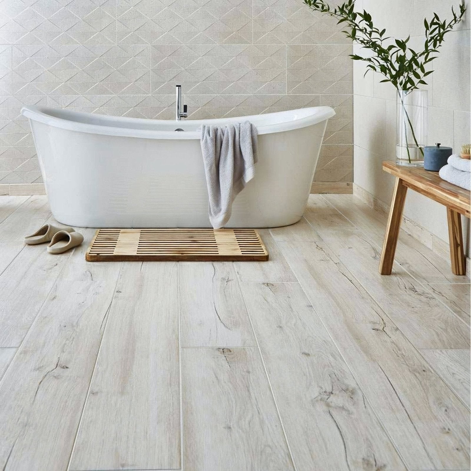 White freestanding bathtub with sleek curved design and chrome faucet in mumble b light oak tiles setting