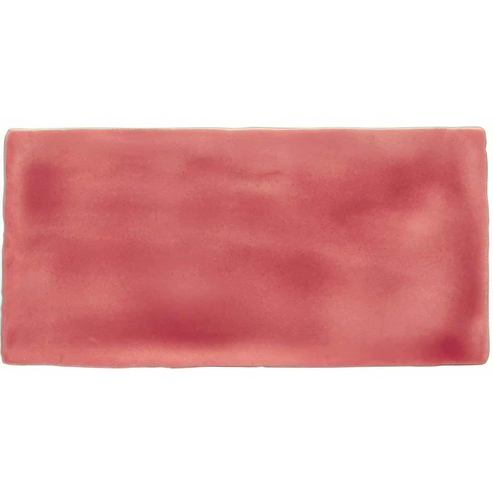 A rectangular ceramic musk half tile wall tile in soft muted coral with subtle tone variations