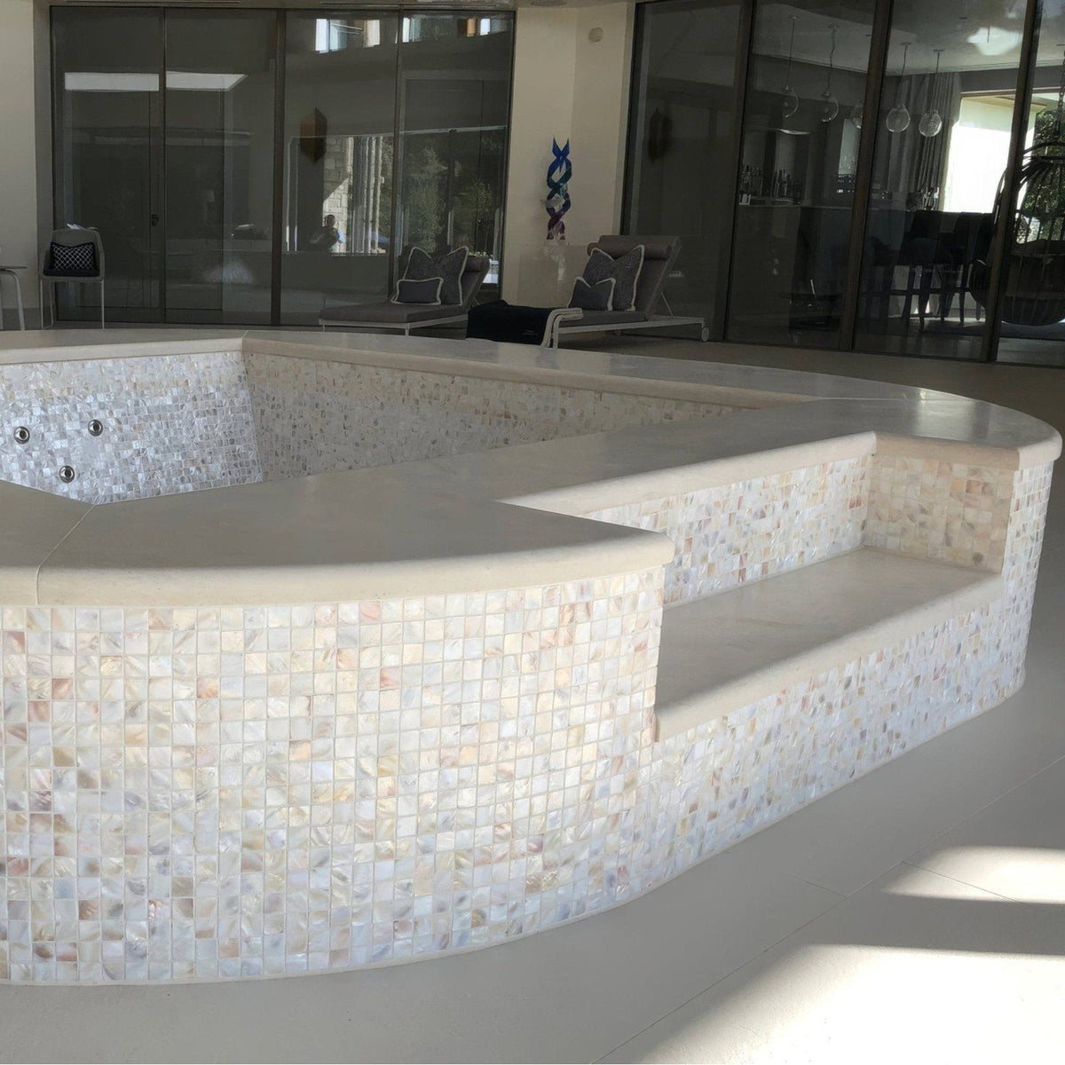 Natural 25mm Square iridescent mother-of-pearl mosaic on a curved multi-tiered hot tub