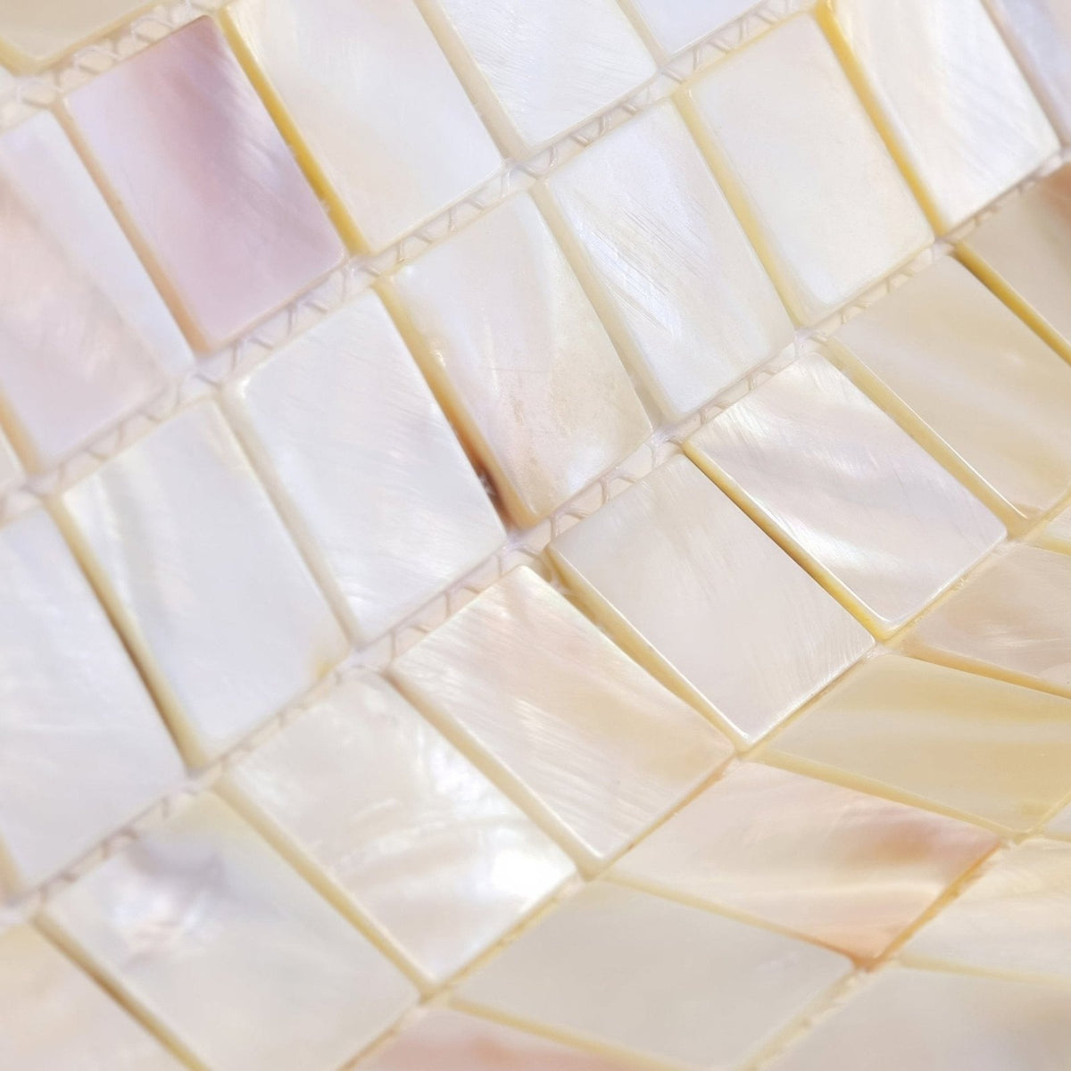 Iridescent mother-of-pearl mosaic tiles natural 25mm square in a subtle pink cream and white gradient color