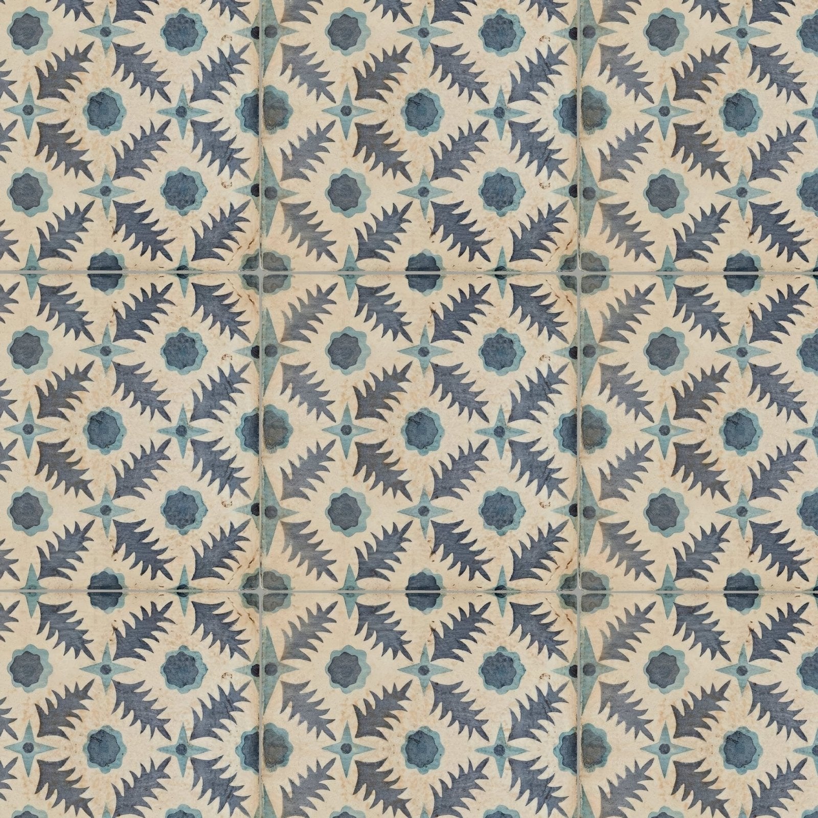 Vintage-style ceramic tiles featuring a repeating dark blue and teal leafy pattern on an off-white background by neisha crosland