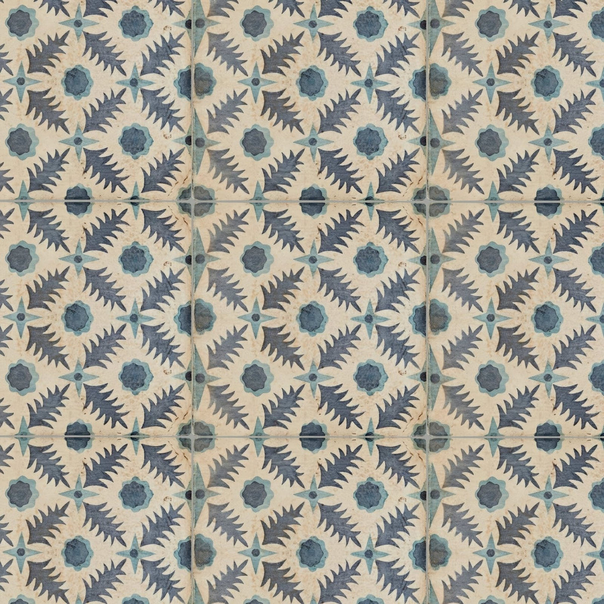 Vintage-style ceramic tiles featuring a repeating dark blue and teal leafy pattern on an off-white background by neisha crosland