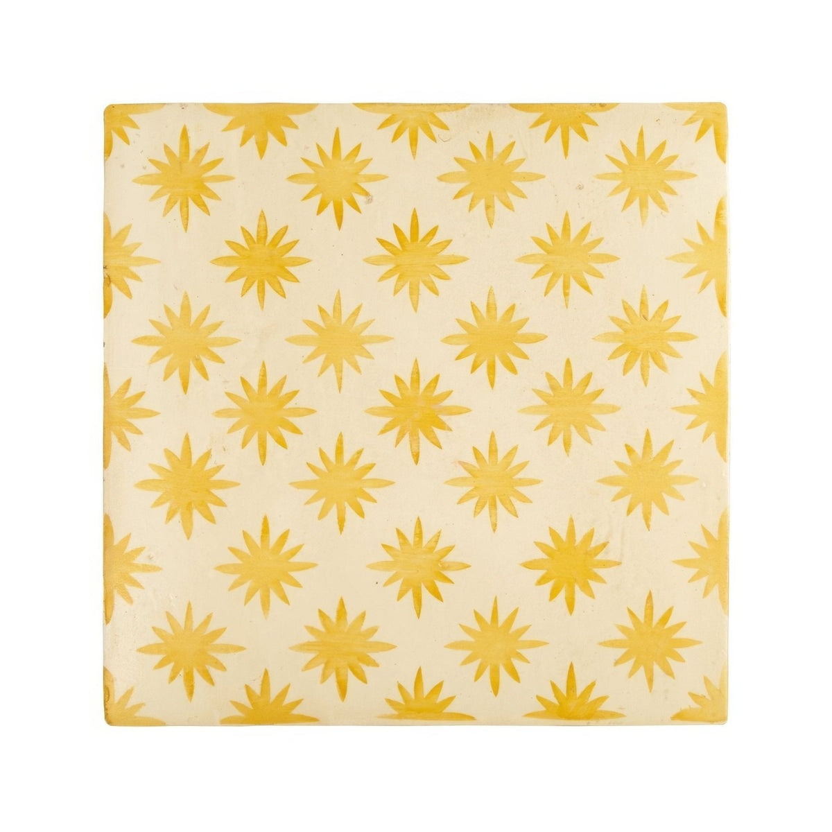 Cream-colored ceramic tile with golden-yellow starburst pattern from neisha crosland atlas star anise buttercup collection
