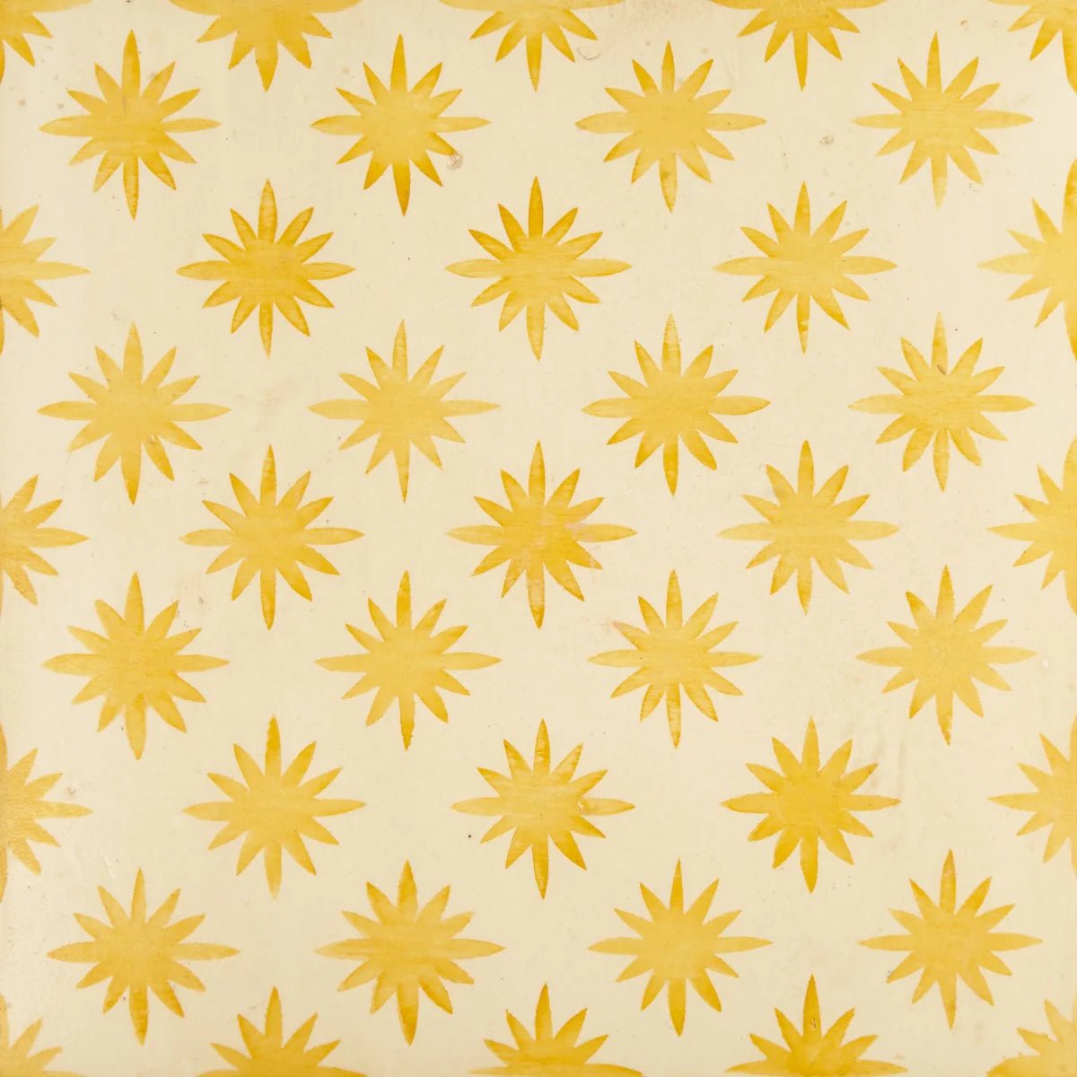 Neisha crosland atlas star anise buttercup wallpaper featuring yellow star patterns on a creamy off-white background