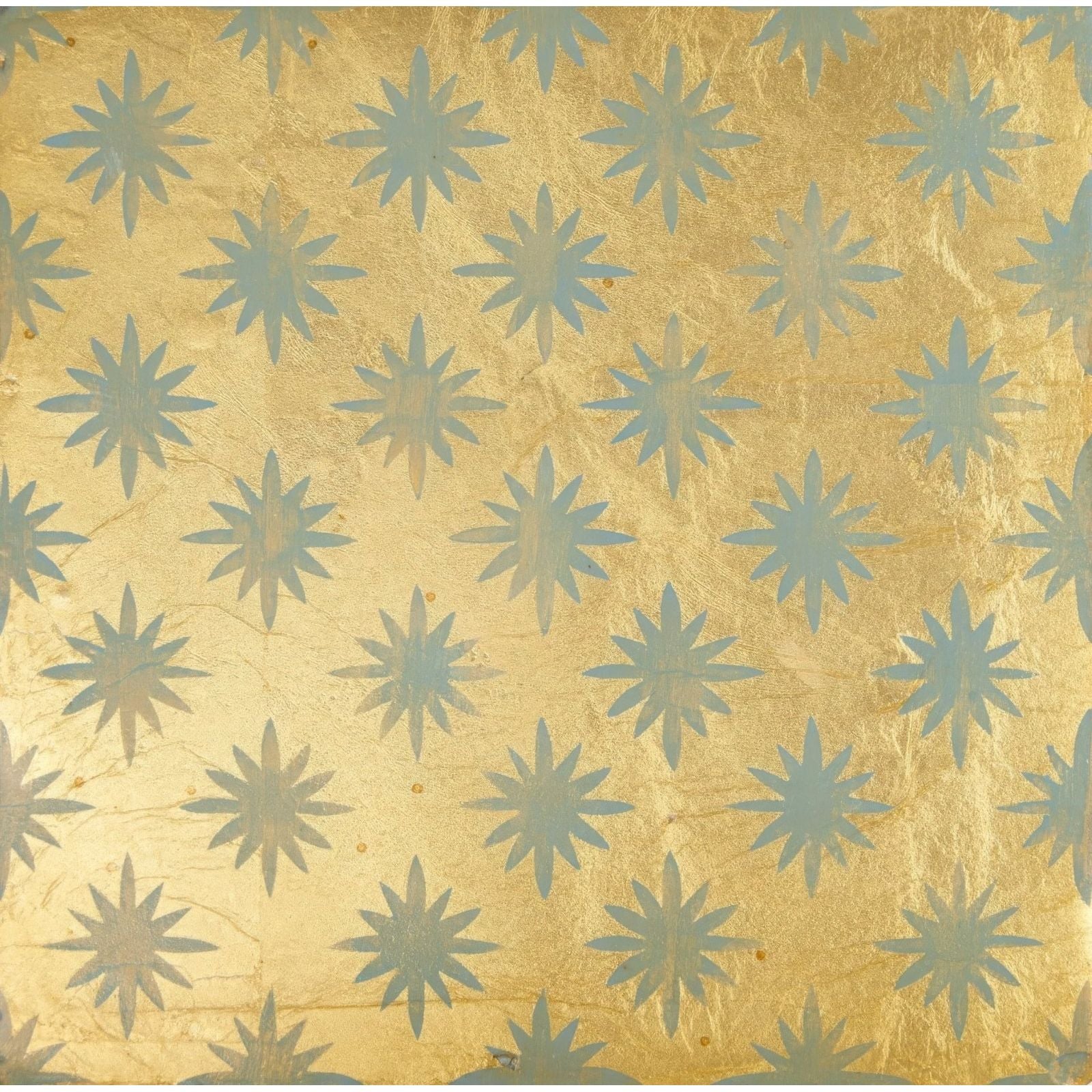 Golden foil wallpaper with a repeating pattern of light blue starburst motifs from neisha crosland atlas star anise sahara
