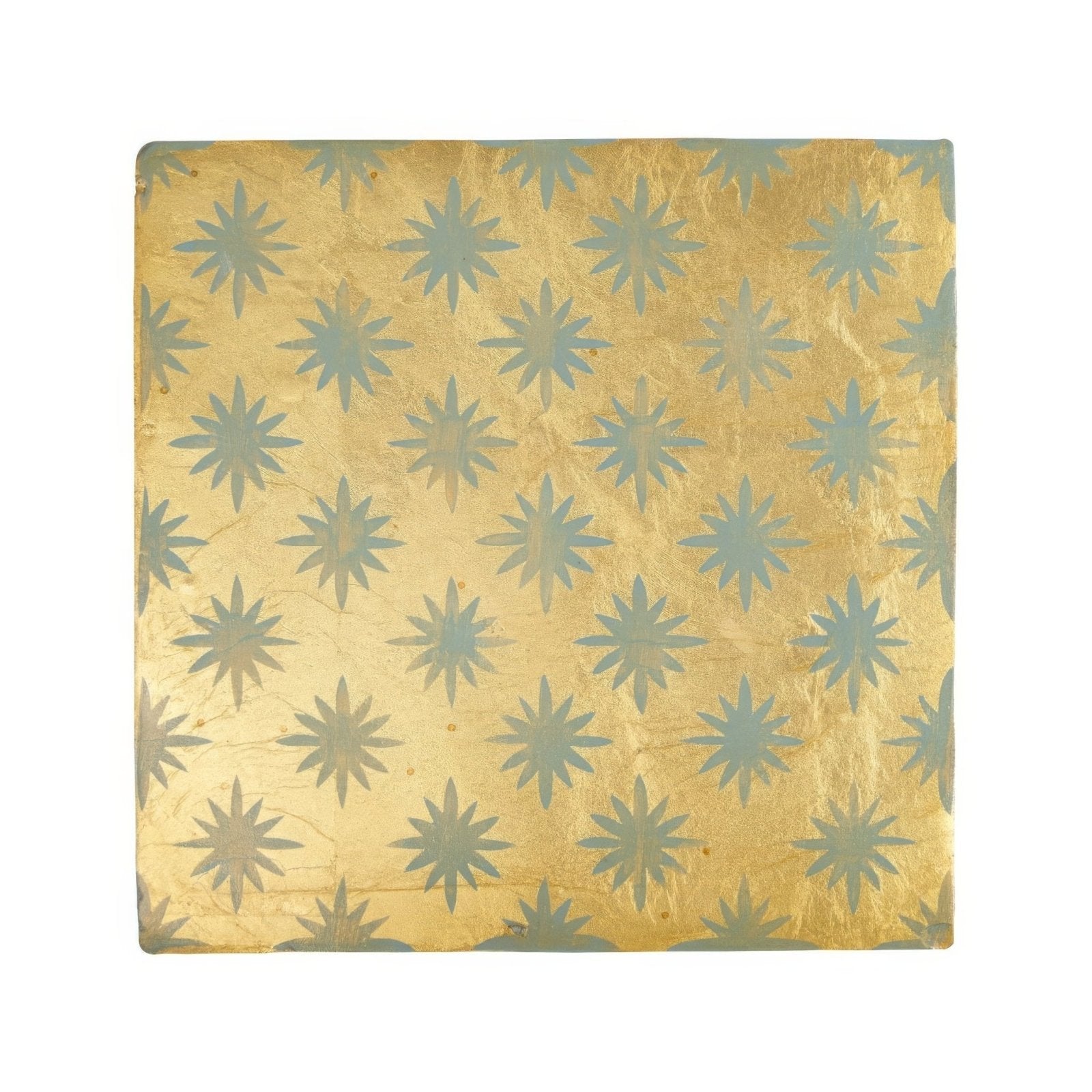A neisha crosland atlas star anise sahara square decorative tile with a golden metallic surface and blue starburst pattern